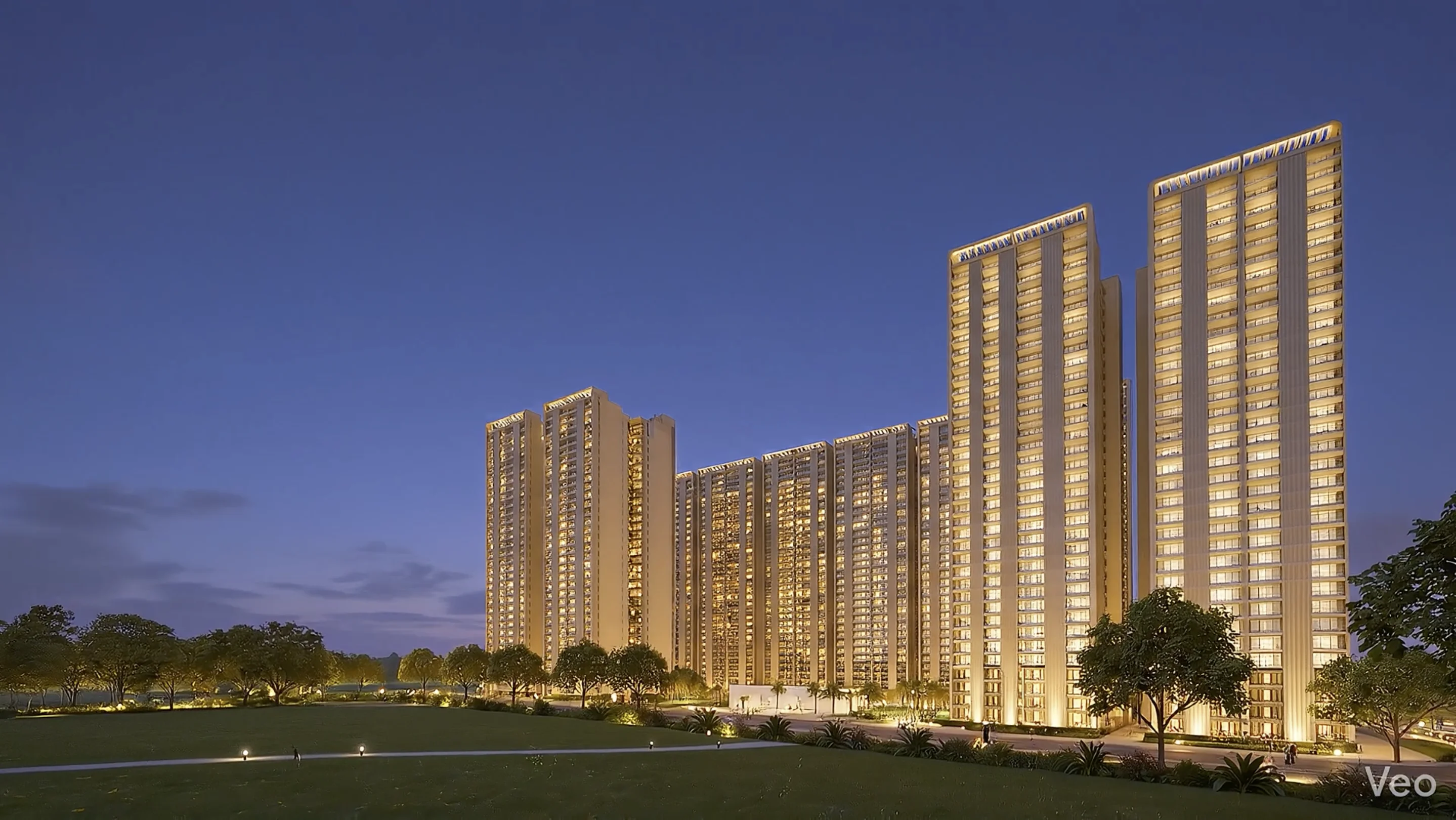 Dusk exterior view of Forbes Fab Luxe Residences towers with landscape